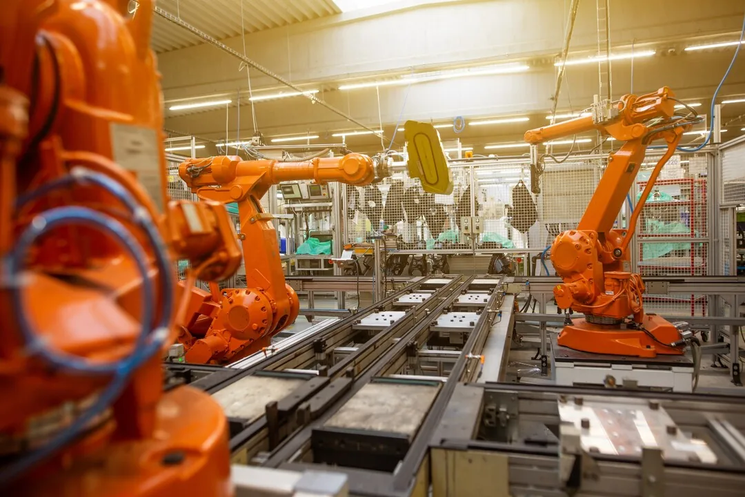 Robotic arms working along an automated production line